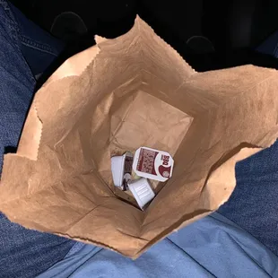 a person holding a brown paper bag