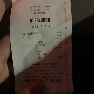 a hand holding a receipt