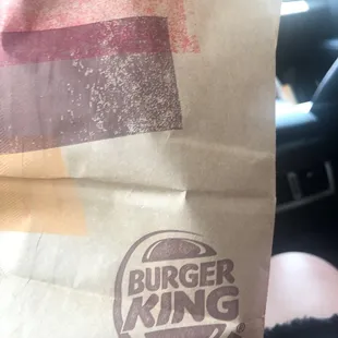 a person holding a bag of food