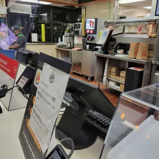 a counter with a menu and a phone