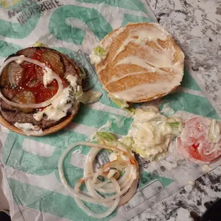 Rude employee dumped mayo on burger and added way too many onions.