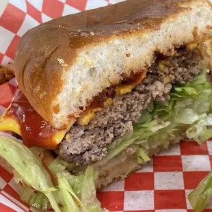 a hamburger cut in half with lettuce and ketchup
