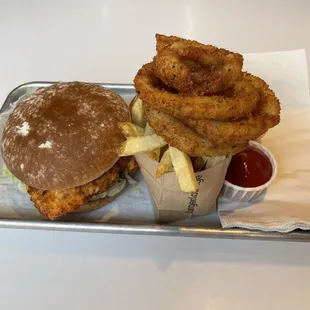 Crispy Chicken Sandwich with 1/2 French fries and 1/2 Onion rings.