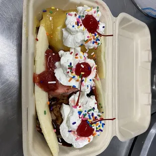 a banana split with whipped cream and toppings
