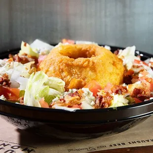 Steakhouse Salad topped with a Thick, hand cut &amp; Battered Onion Ring