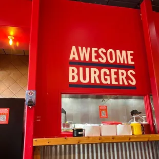 awesome burgers sign above counter