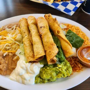 The freshly made Taquito plate, rice, beans, salad with great guacamole and sour cream