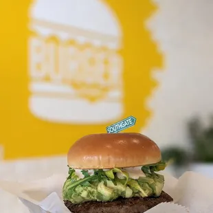 a hamburger with avocado and lettuce