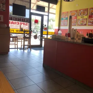 Sitting area next to soda machine.