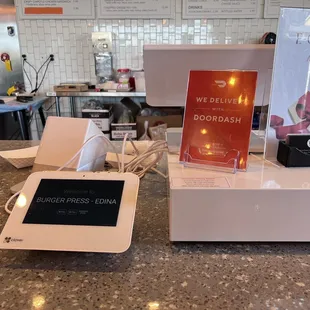 a menu and a tablet on a counter