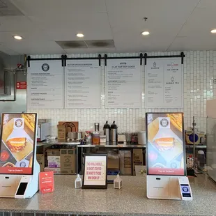 Menu on the wall with order station on the foreground