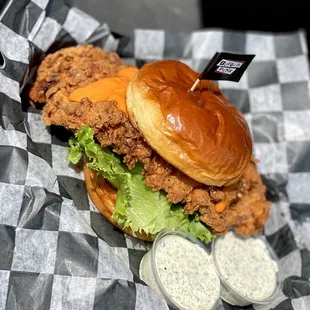 a chicken sandwich with lettuce and ranch dressing