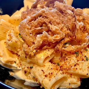 a plate of pasta with fried onions