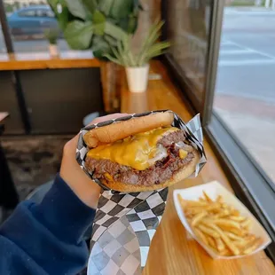 a person holding a sandwich