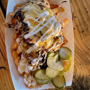 a plate of fries and pickles