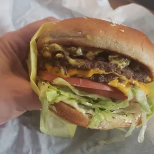 Double cheeseburger w/pickled jalapeños, all the way, with mustard.