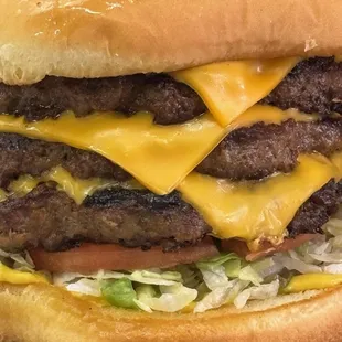 Our Triple Jumbo Cheeseburger.  Seasoned to perfection - Dressed any way you like it.  Take it on if you dare