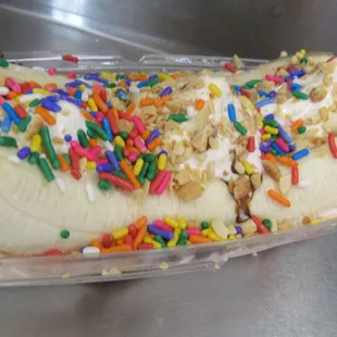 Pictured is a Banana Split with chocolate drizzle and sprinkles.  Our Banana Split normally comes with Chocolate, Strawberry and pineapple