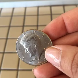 a person holding a penny in their hand