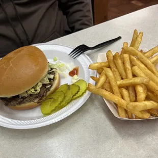 a plate with fries and a pickle