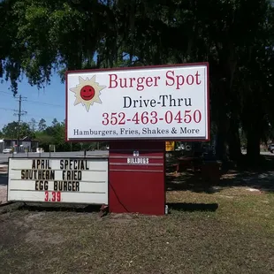 a sign for burger spot drive thru