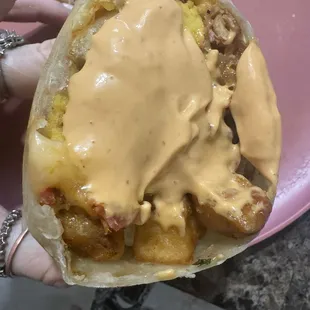 Tasty half with their hot sauce. Not a big fan of it. Took it off. Not really hot, but Great breakfast burrito!