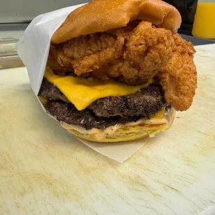 Customer came in and customized his burger and added chicken tenders on the burger.