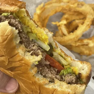 Thin beef patty from the griddle on a toasted bun with all the fixings.
