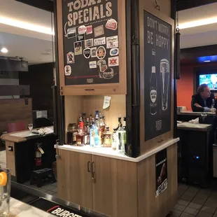 a bar with a menu on the wall