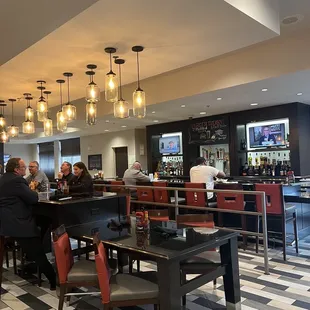 people sitting at the bar in a restaurant