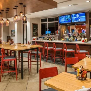 a restaurant with a bar and televisions