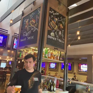 a man holding a beer in a restaurant