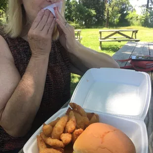 a woman sitting at a picnic table