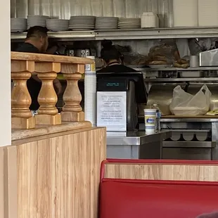 a view of the kitchen from inside the restaurant