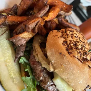 a hamburger and fries on a plate