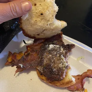 a hand holding a piece of bread