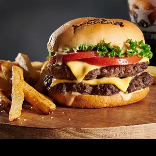 a burger and fries on a cutting board