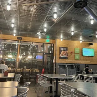 the inside of a restaurant with tables and chairs