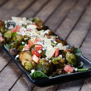 a plate of brussels sprouts and tomatoes