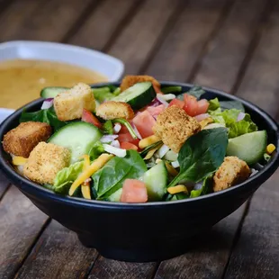 a bowl of salad with croutons