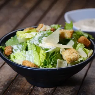 a bowl of salad with croutons