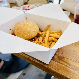 a burger and fries on a table