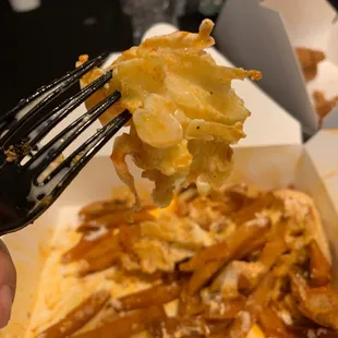 a fork lifting a bite out of a box