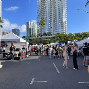 a crowd of people at a street fair