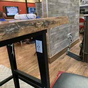 Convenient outlets under the high-top tables for people who like charging their electronics or using their computer while eating!