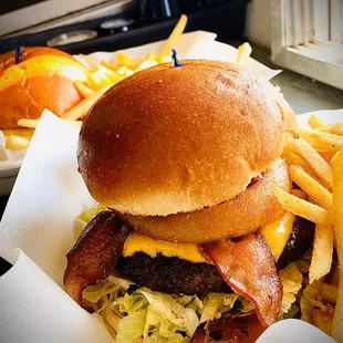 BAMCO&apos;s Kick&apos;n Cowboy w/ bacon, BBQ sauce, beer battered onion rings on a Brioche bun &amp; our delicious seasoned fries