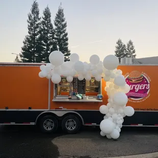 a food truck decorated with balloons