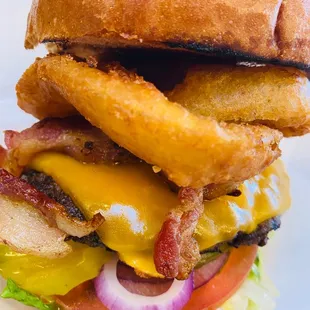 a burger with onion rings
