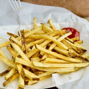 a basket of fries and ketchup