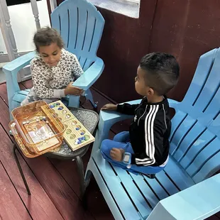 two children playing on a deck